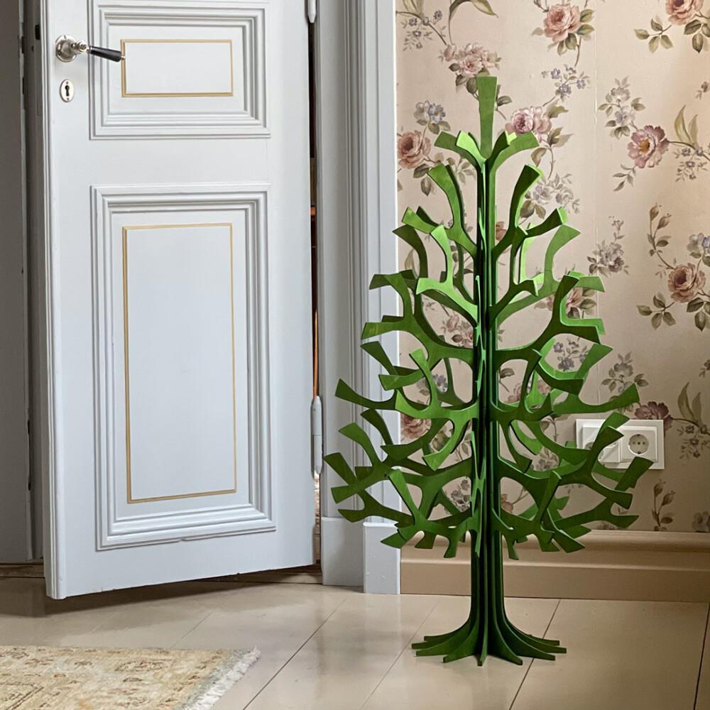 Lovi Spruce 100cm, wooden Christmas tree, in the corner of an old house. Color forest green.