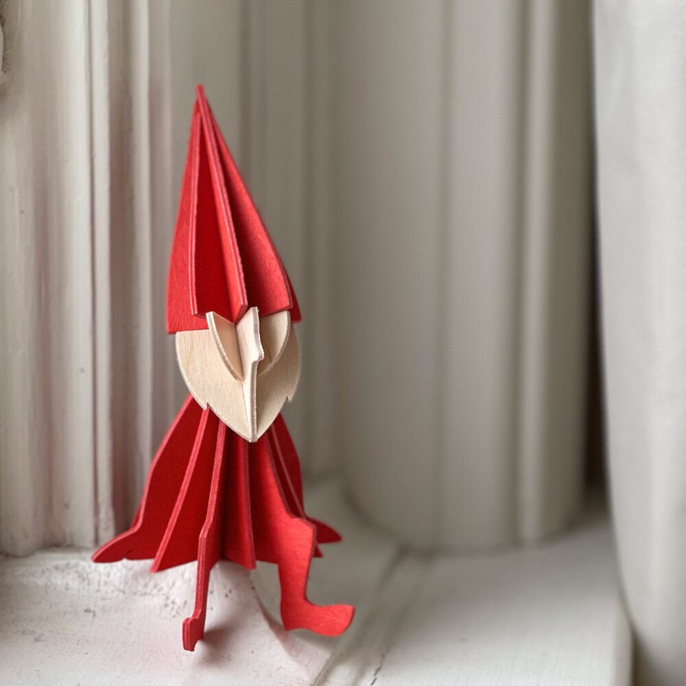 Wooden Lovi Elf, color bright red, sitting on the windowsill, wooden elf decoration.