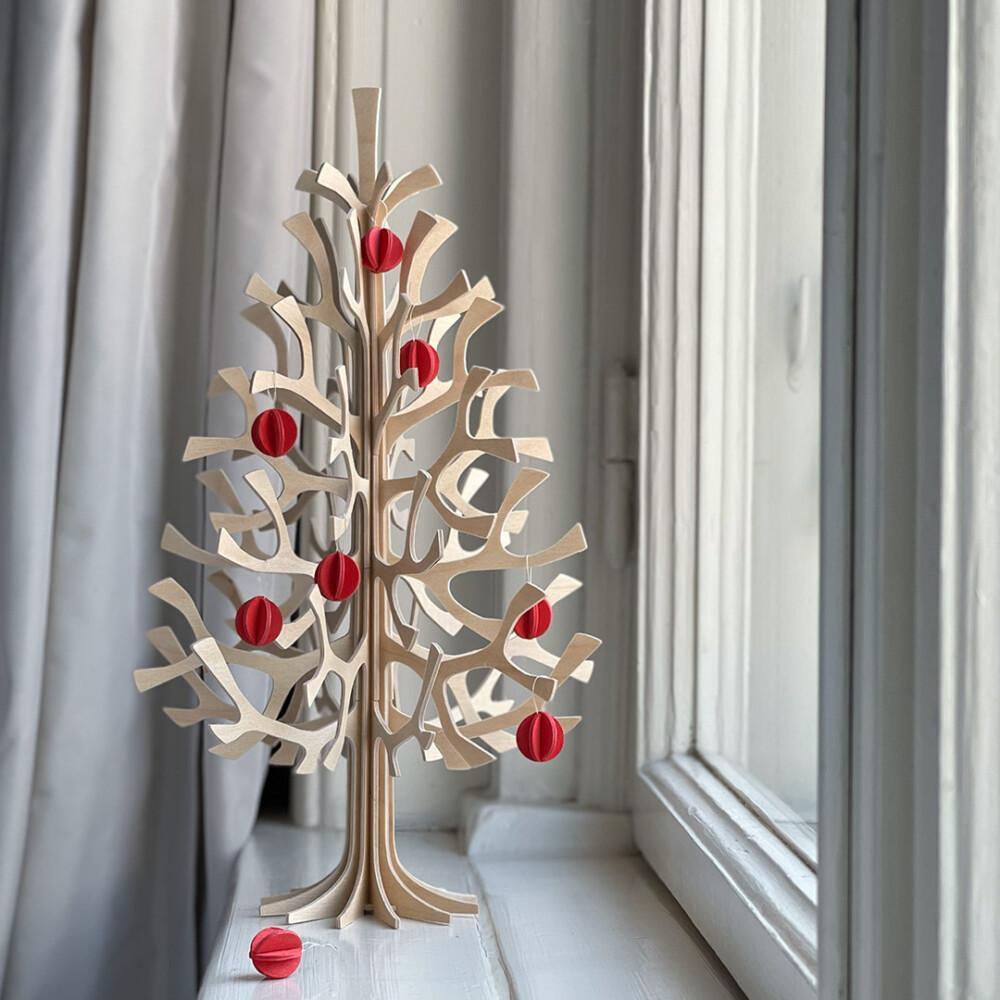 Lovi Spruce 30cm natural wood with bright red Minibaubles on windowsill. Wooden Christmas tree.