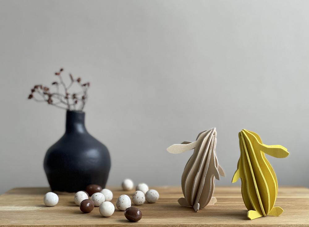 Lovi Rabbits, wooden 3D figures, natural wood and yellow with a vase.