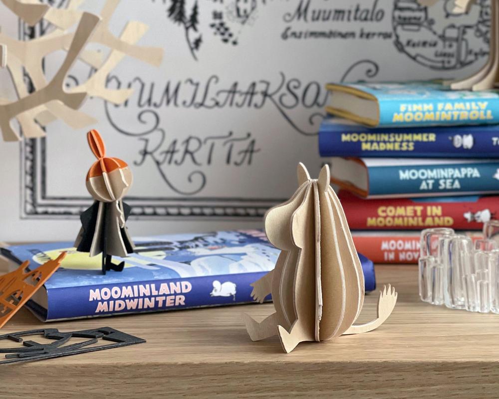Little My and Moomintroll by Lovi with a book Moominland Midwinter.