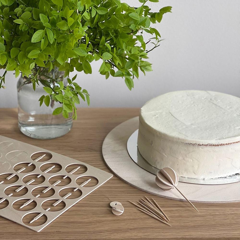 Use natural material as easy cake decoration ideas. Wooden Lovi Baubles will work perfectly.