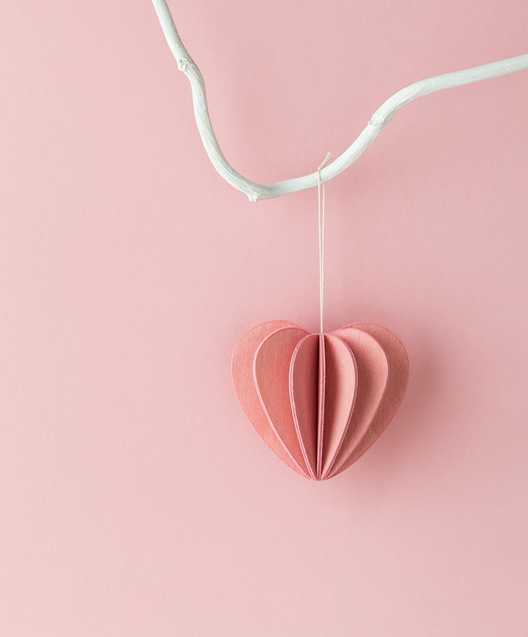 Wooden Lovi Heart, light pink hanging on the branch