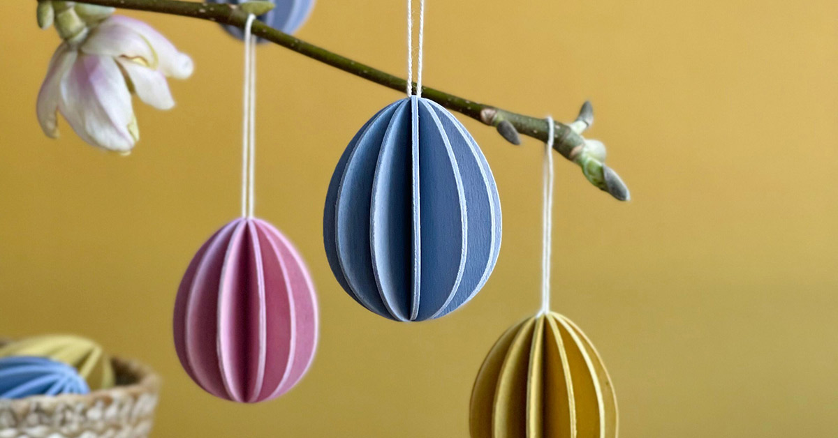 Lovi Eggs on the branch, wooden Easter eggs in flax blue, light pink and honey yellow