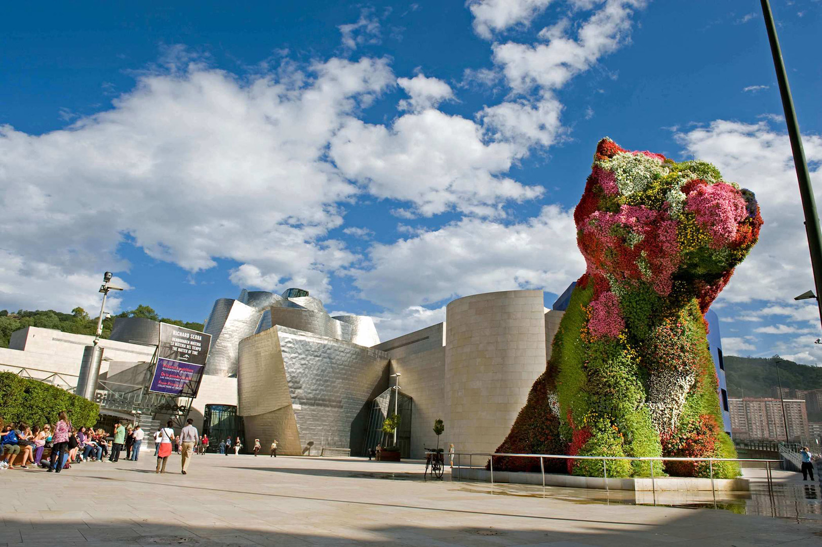 Puppy by Jeff Koons decorated with flowers in the yard of Guggenheim museum Bilbao.