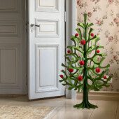 Lovi Spruce 120cm, wooden Christmas tree, in the corner of an old house. Color forest green. Decorated with bright red Lovi Baubles