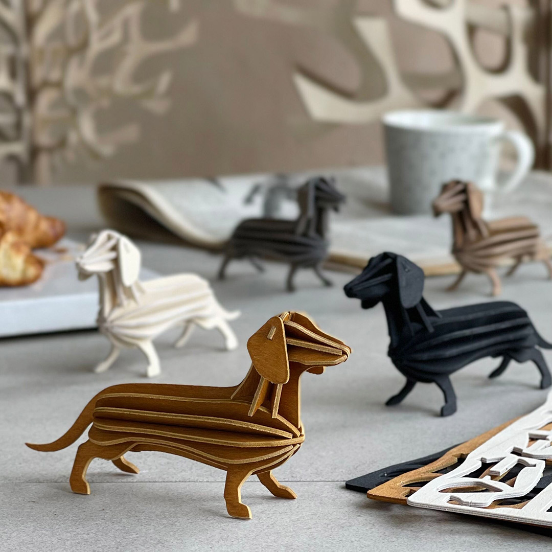 Lovi Dachshunds, wooden dachshund figures, on coffee table.