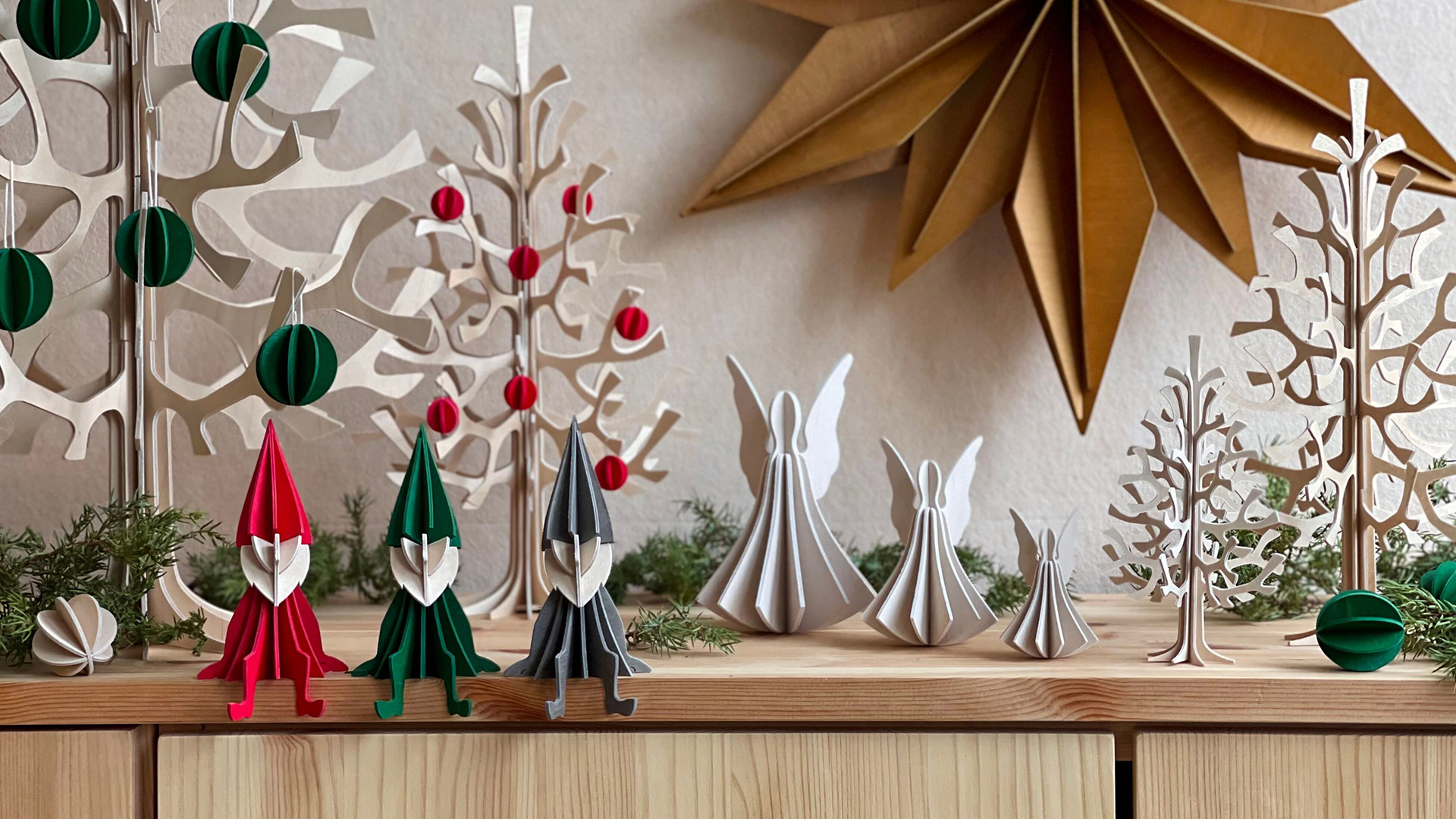 Wooden Lovi products on the sideboard, elves, angels, spruces and stars