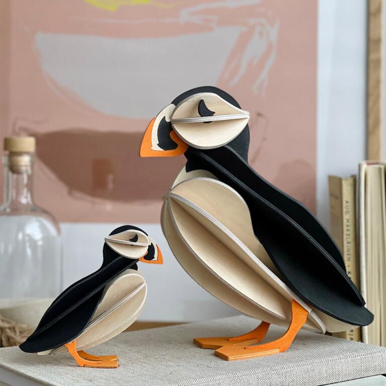Wooden Lovi Puffins 10cm and 20cm, on books.