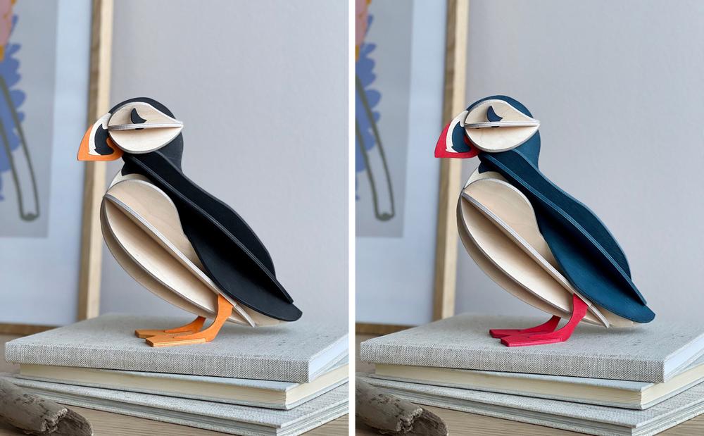 Lovi Puffin 20cm black mix and blue mix standing on the pile of books
