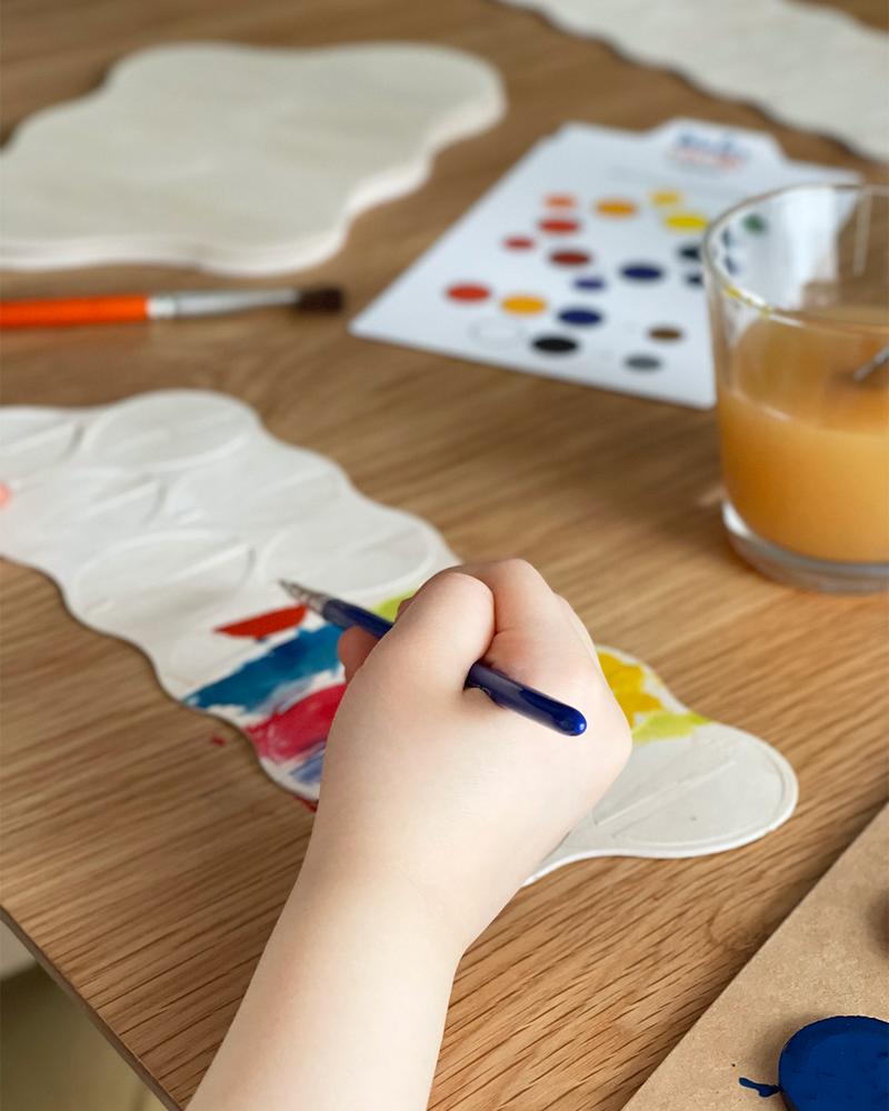 A small child painting Lovi Eggs for Easter decoration.