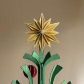 Wooden Lovi Decor Star 10cm in Honey Yellow, used as a Christmas tree topper.