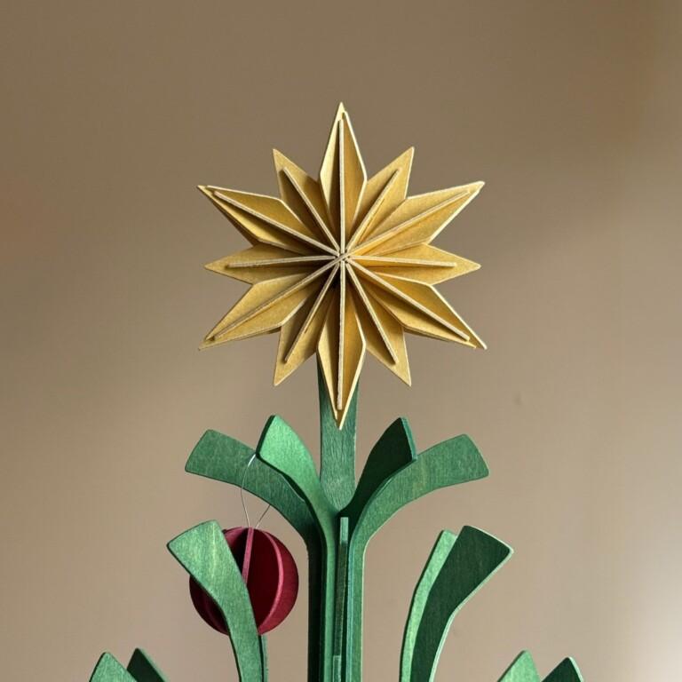 Wooden Lovi Decor Star 10cm in Honey Yellow, used as a Christmas tree topper.
